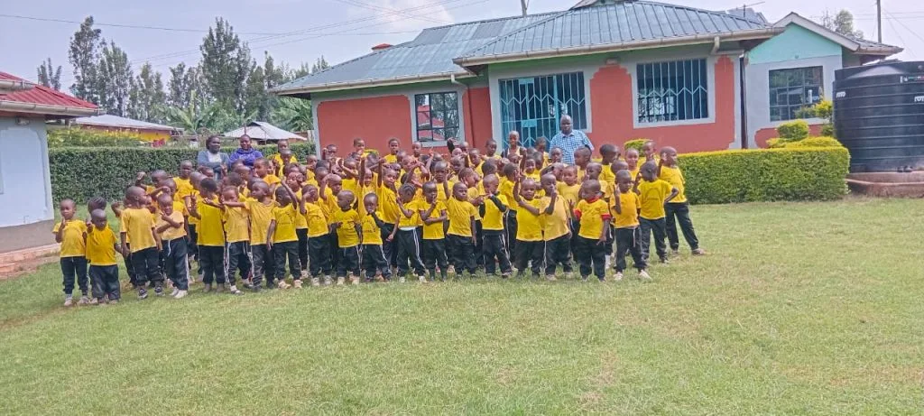 Schoolchildren gathered on the lawn outside their classrooms