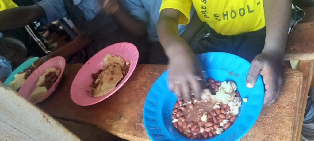 A child enjoying a meal through the Restoration feeding program