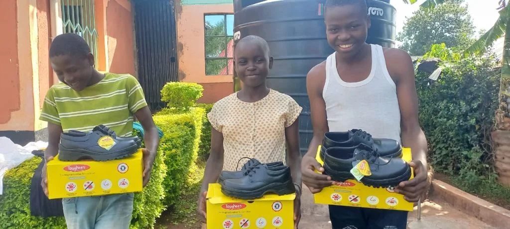 Women holding supplies during a Restoration community support activity