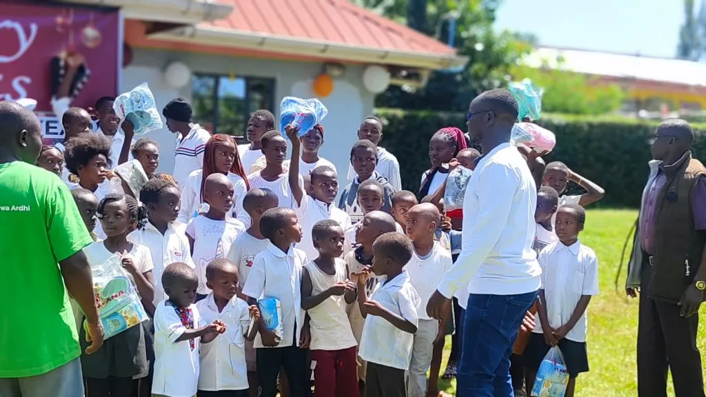 Children and adults celebrating together outdoors at Restoration